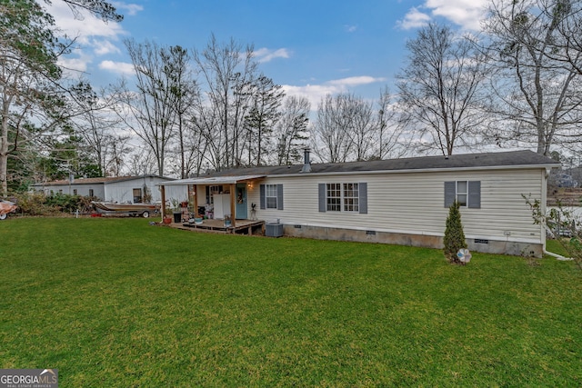 rear view of property with a lawn