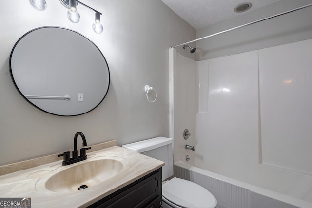 full bathroom with a textured ceiling, bathtub / shower combination, vanity, and toilet