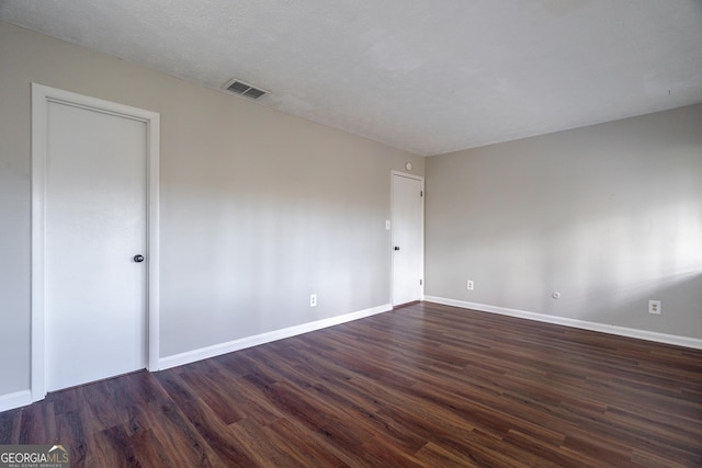 empty room featuring dark hardwood / wood-style flooring