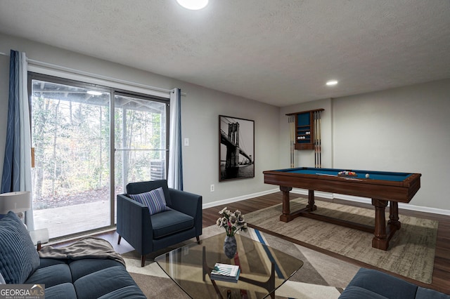 rec room with a textured ceiling, billiards, and hardwood / wood-style floors