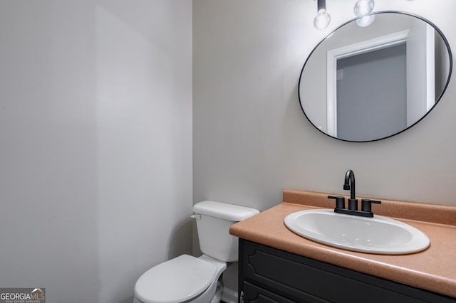 bathroom with toilet and vanity