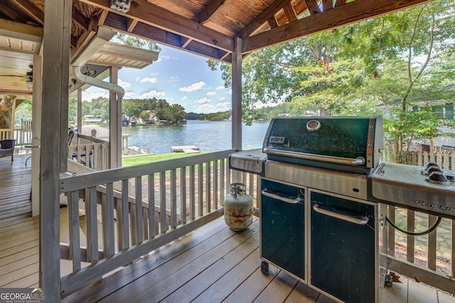 deck with a water view and grilling area