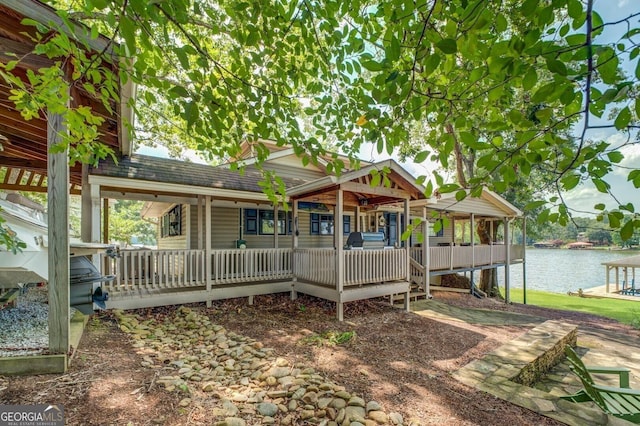 rear view of house featuring a water view