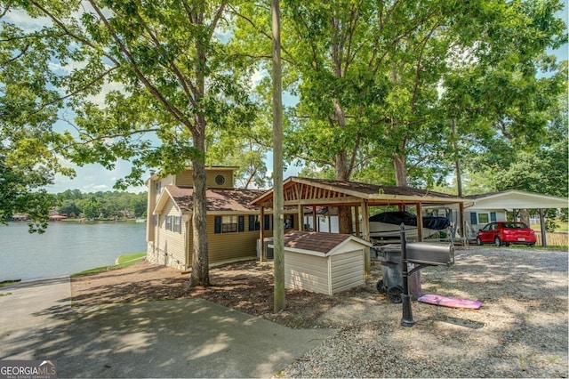 view of front of property featuring a carport and a water view