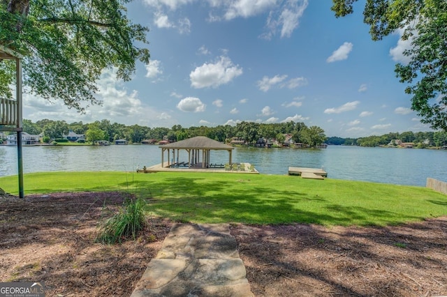 exterior space with a gazebo, a water view, and a lawn