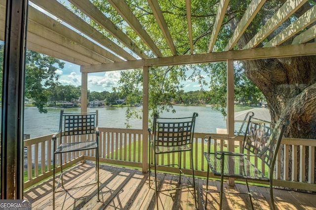 wooden terrace featuring a water view