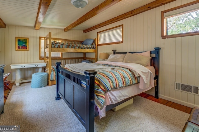 bedroom with hardwood / wood-style flooring and beam ceiling