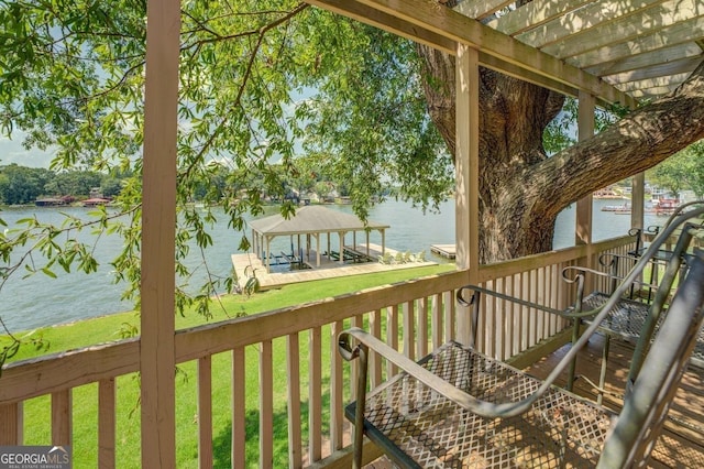 wooden terrace with a pergola, a lawn, a water view, and a boat dock