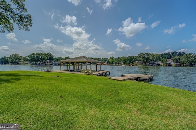 dock area featuring a water view and a lawn