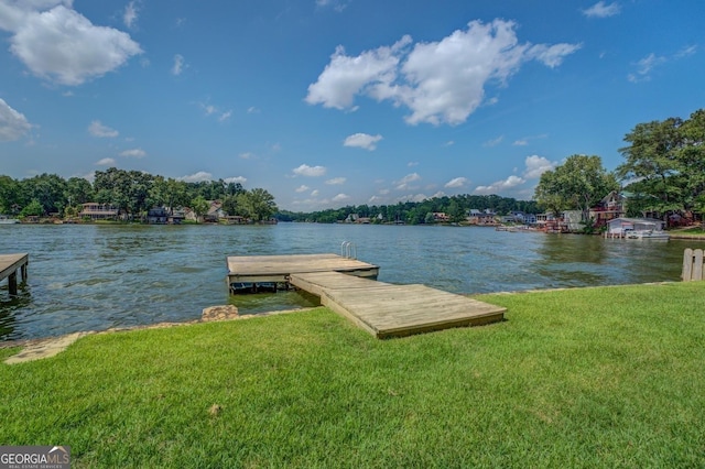 dock area featuring a water view and a lawn