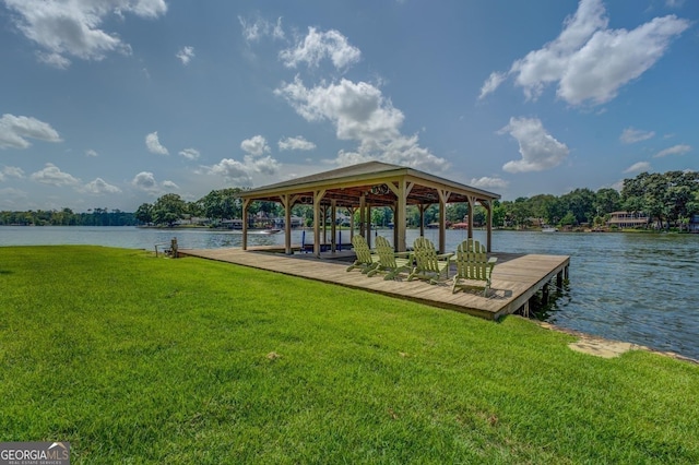 dock area with a water view and a yard