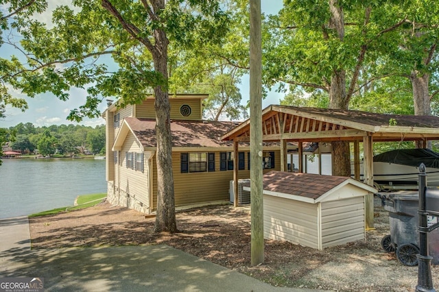 view of front facade featuring a water view and a carport