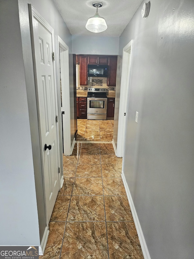 hallway with a textured ceiling