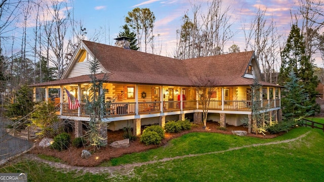 back house at dusk with a yard