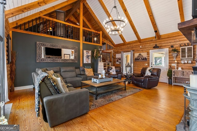 living room featuring log walls, beamed ceiling, high vaulted ceiling, hardwood / wood-style floors, and a chandelier