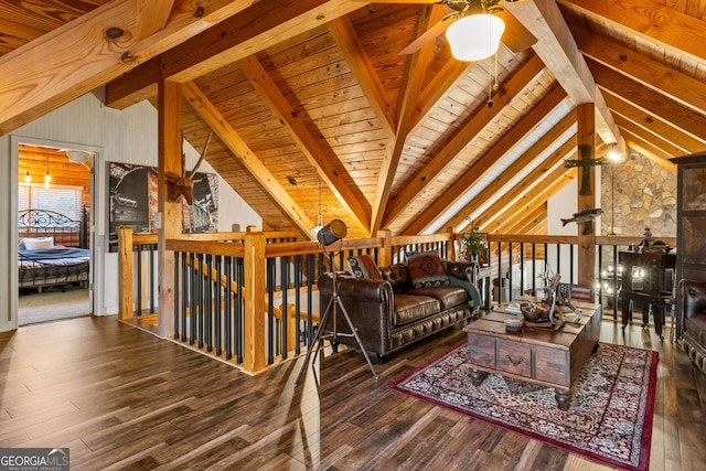 living area with ceiling fan, lofted ceiling with beams, dark hardwood / wood-style flooring, and wood ceiling