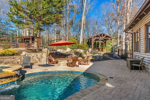 view of pool featuring a gazebo, a patio, an in ground hot tub, and pool water feature