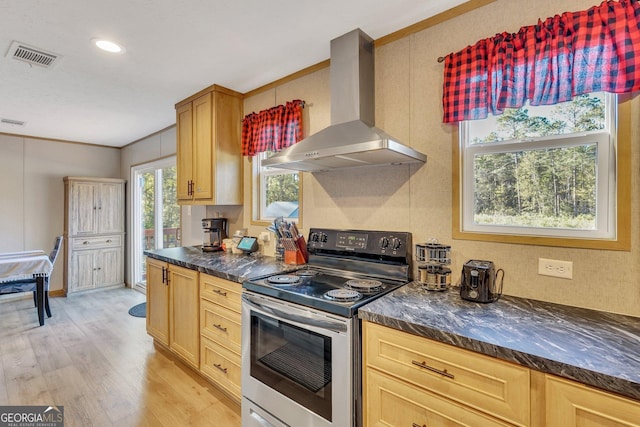 kitchen featuring light brown cabinets, light hardwood / wood-style flooring, electric range, wall chimney exhaust hood, and ornamental molding