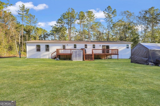 back of property with a lawn, a shed, and a deck