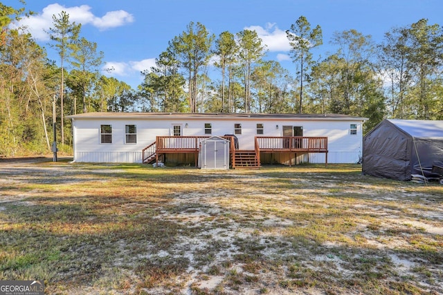 back of property featuring a shed and a wooden deck