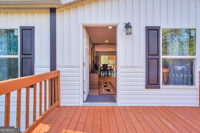 view of exterior entry featuring a wooden deck