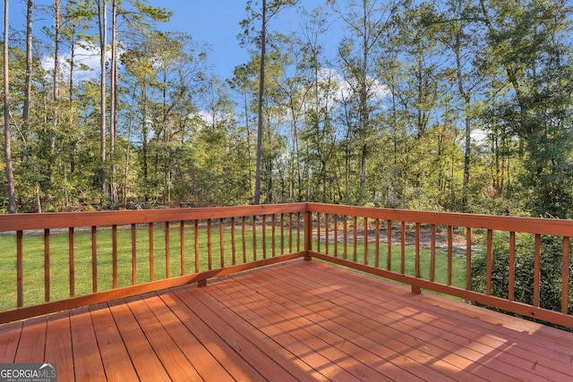 wooden deck featuring a lawn