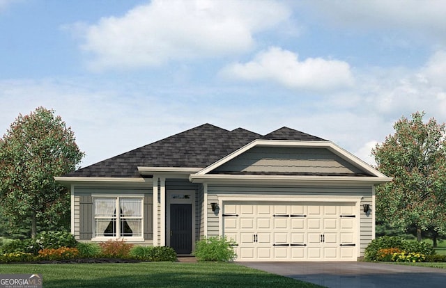 view of front of home featuring a front yard and a garage