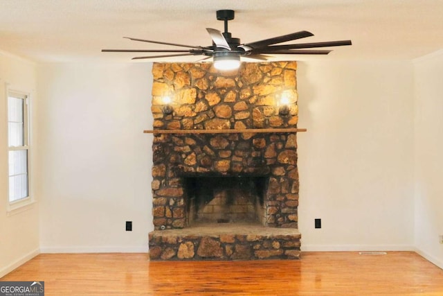 living room featuring a fireplace and wood-type flooring