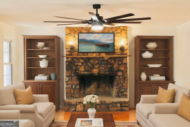 living room featuring plenty of natural light, light wood-type flooring, and a fireplace