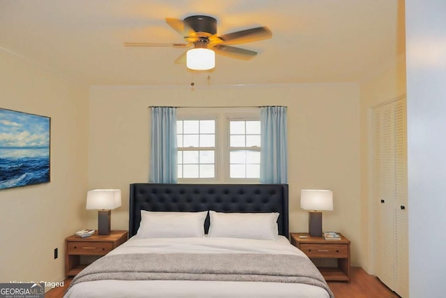 bedroom featuring ceiling fan, a closet, and hardwood / wood-style floors