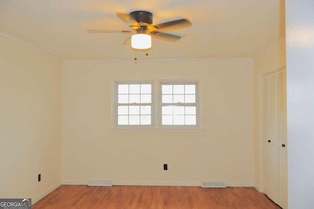 unfurnished room featuring hardwood / wood-style floors and ceiling fan