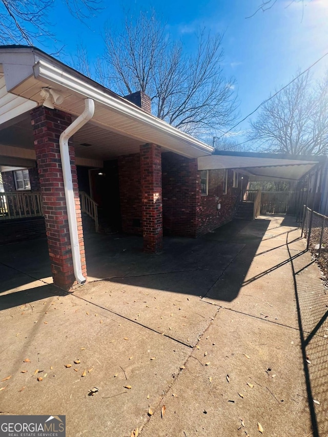 view of property exterior with a carport