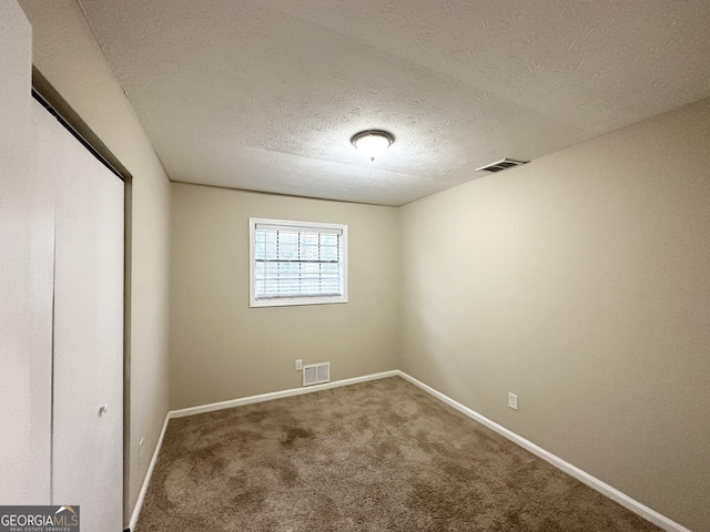 unfurnished bedroom with carpet and a textured ceiling