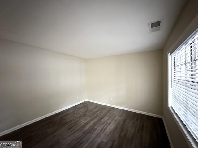 unfurnished room featuring dark hardwood / wood-style flooring