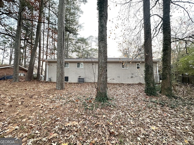 rear view of property featuring cooling unit