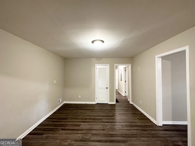 unfurnished room with dark hardwood / wood-style floors