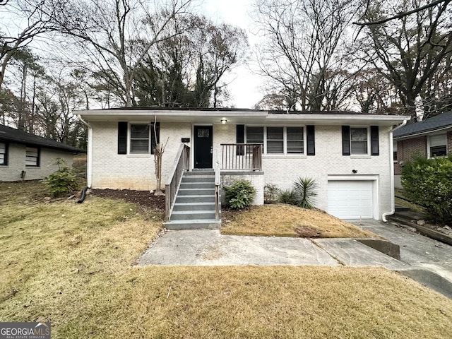 view of front of property with a garage and a front yard