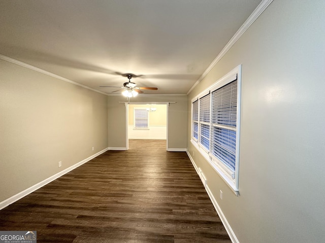 spare room featuring crown molding, dark hardwood / wood-style flooring, and ceiling fan with notable chandelier