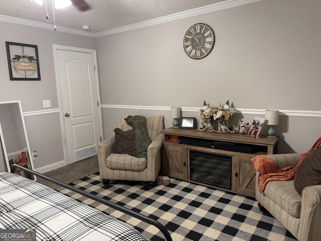 living room featuring light carpet, ceiling fan, a textured ceiling, and ornamental molding