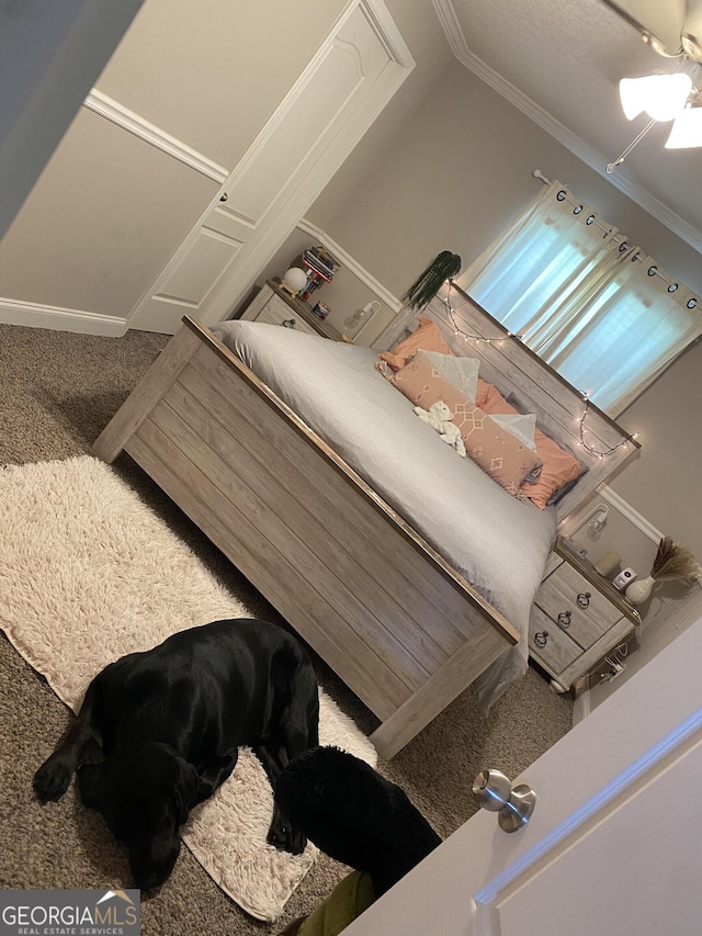 bedroom featuring carpet floors, ceiling fan, and ornamental molding