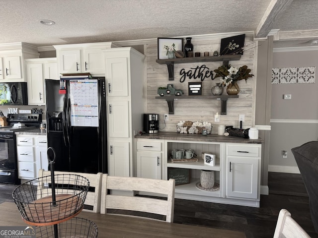 kitchen featuring black appliances, white cabinetry, and a textured ceiling