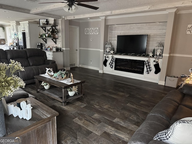 living room featuring dark hardwood / wood-style flooring, ceiling fan, crown molding, and a textured ceiling