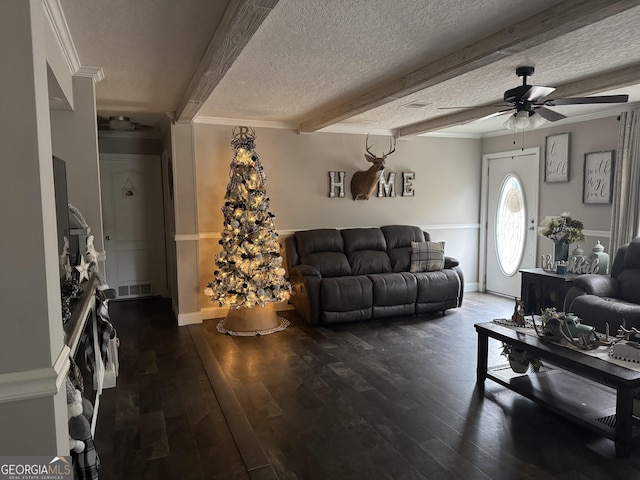 living room featuring a textured ceiling, ceiling fan, crown molding, dark wood-type flooring, and beamed ceiling