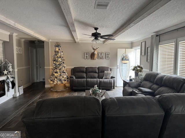 living room with ceiling fan, dark hardwood / wood-style floors, crown molding, and a textured ceiling