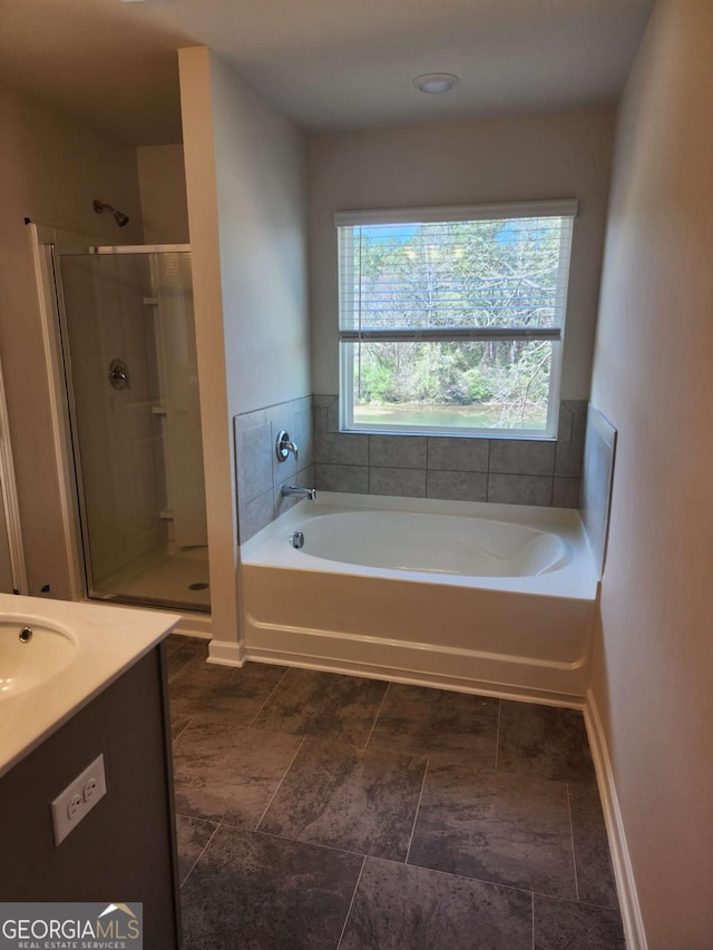 bathroom featuring vanity and separate shower and tub