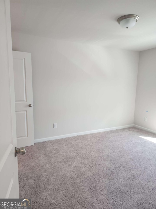 spare room featuring carpet floors