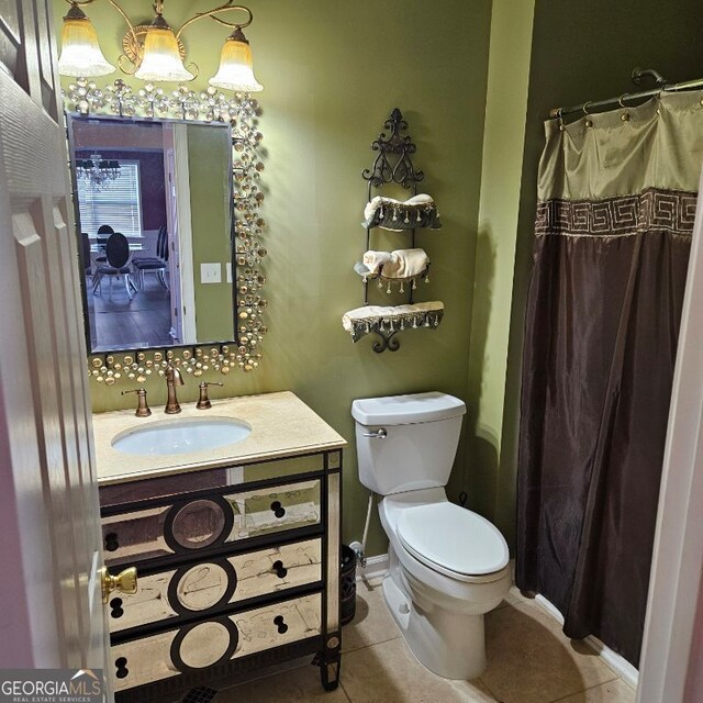 bathroom with tile patterned flooring, vanity, and toilet