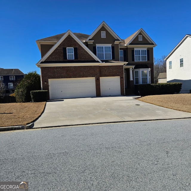 craftsman-style house with a garage, brick siding, and driveway