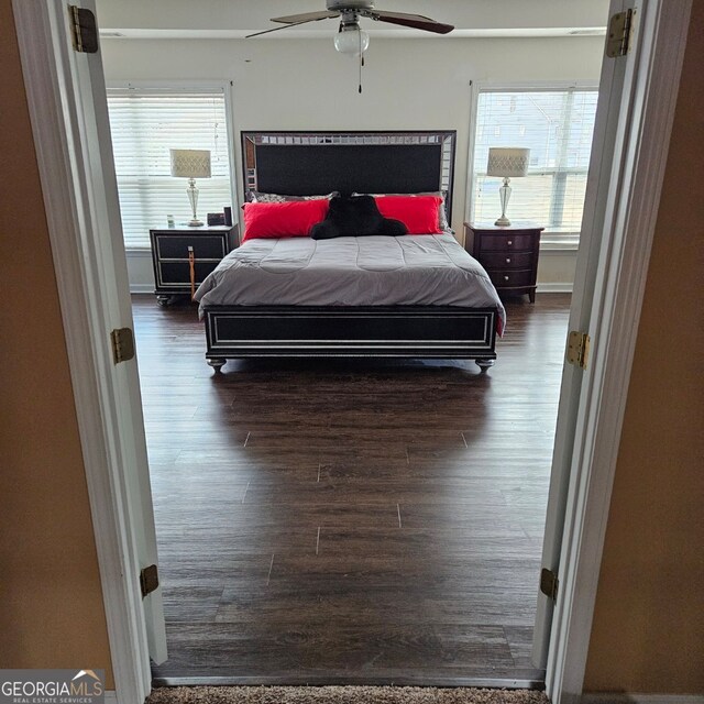 bedroom with ceiling fan and dark hardwood / wood-style flooring