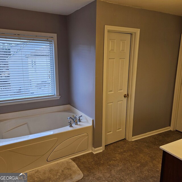 bathroom featuring vanity and a tub